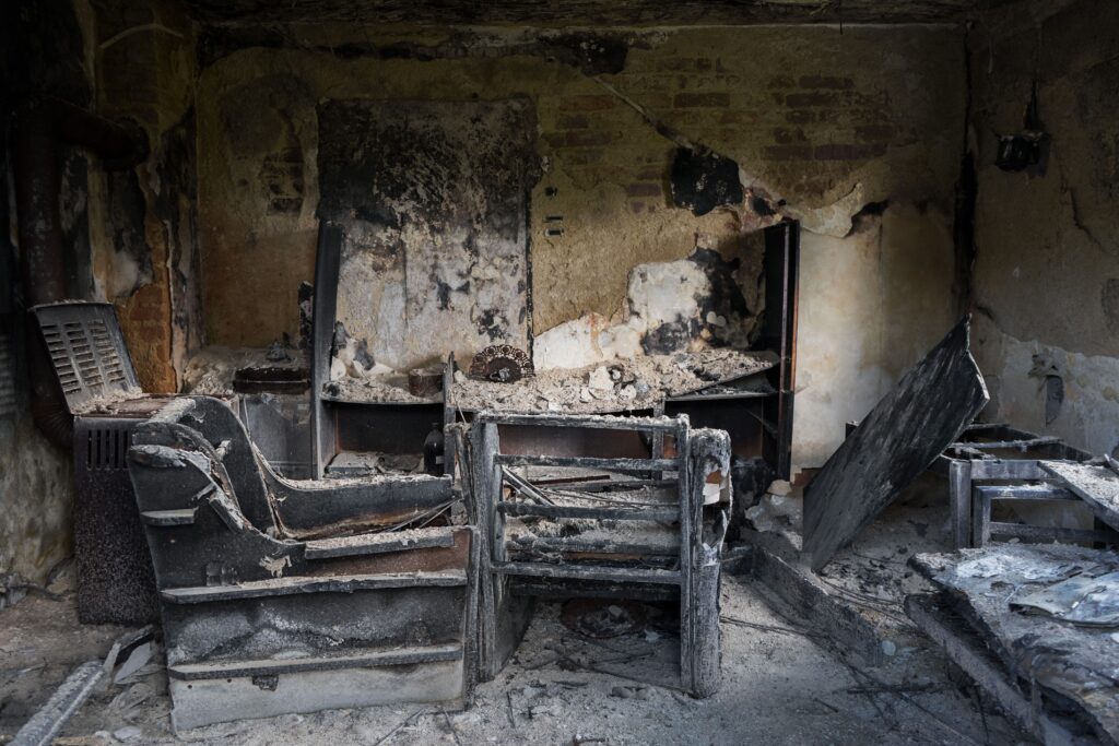 Charred furniture and burned interior of a home after fire