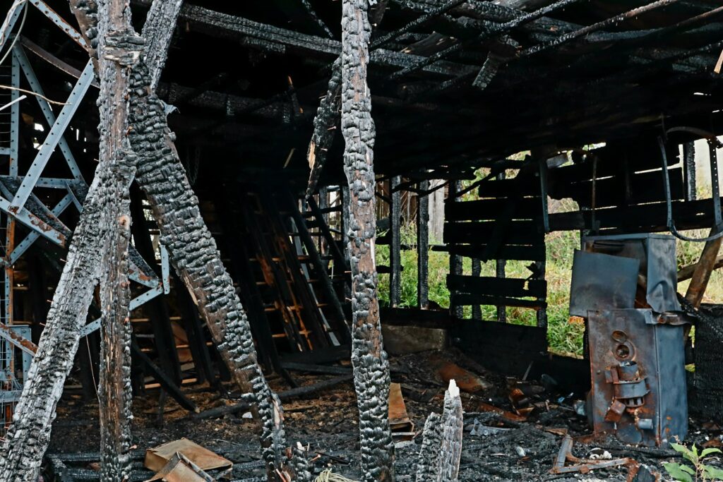 Charred wooden beams and burnt interior after fire damage